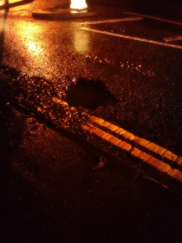 PhysicallyFitPT's tweet photo. @TandridgeDC pothole at the end of Coulsdon road just before a roundabout. Very dangerous! Caused me a puncture http://t.co/5RpCocZmzW