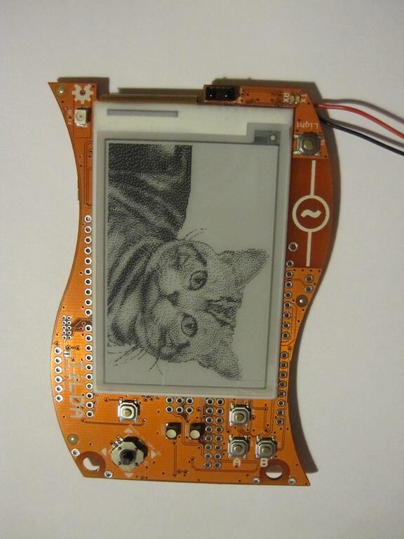 jonty's tweet photo. Prototype @emfcamp badges are stress tested with cat images. http://t.co/qiXX1Hy3M2