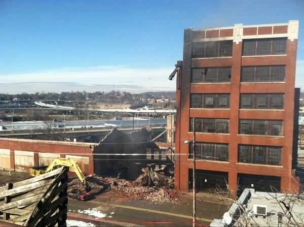 6News's tweet photo. The middle building at McClung Warehouses was demolished moments ago.6 News was on scene at the time. #McClungFire http://t.co/HG4IWdvsfk