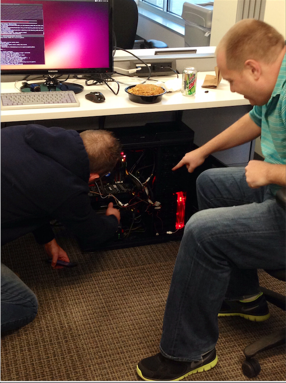 SimpleCoinCo's tweet photo. A few of our guys hacking together our new #altcoin miner. We're losing money each minute this thing isn't running! http://t.co/fvegjmvOpZ