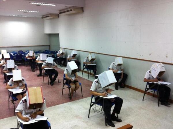 WTFLifeFacts's tweet photo. In China, Some schools make you wear these boxes to prevent cheating http://t.co/usnauVeC0R