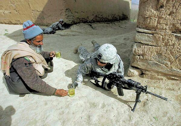 Afghan villager brings #American soldiers occupying his village a cup of tea as a sign of hospitality.