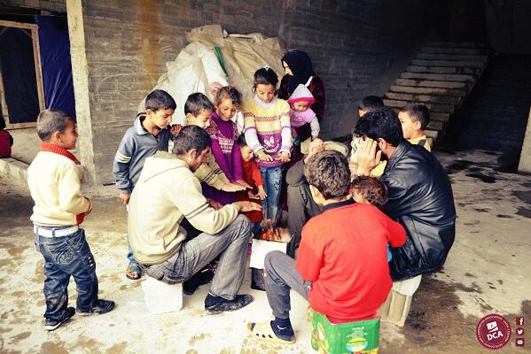 dcalebanon's tweet photo. A number of #Syrian #refugees are trying to get the most possible warmth from this light fire. http://t.co/pSGVmI5egy