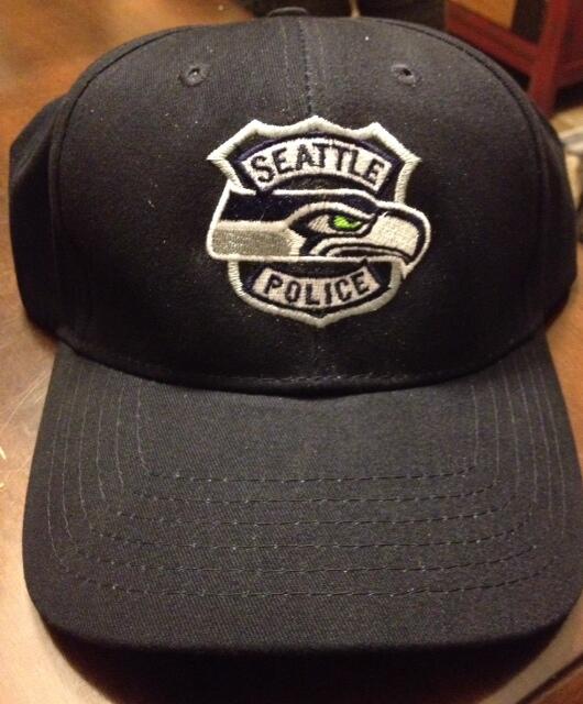 SeattlePD's tweet photo. Thanks to @SeattlePF for providing officers with these awesome hats for the parade! http://t.co/ipVCFr9fhC