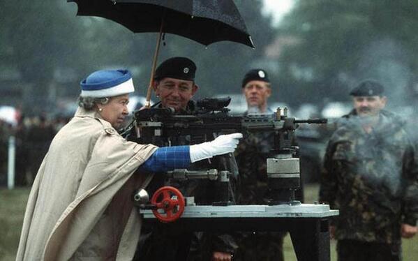 Queen Elizabeth II firing a British L85 battle rifle. Surrey, England, 1993.
