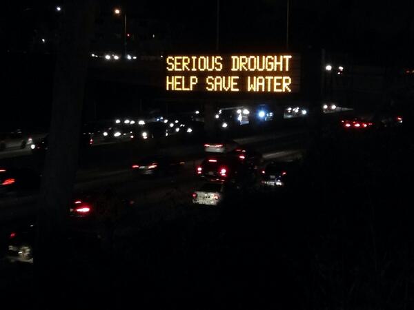 GadiNBC's tweet photo. We watched some cars get drenched by sprinklers on 10 freeway- then have 2 drive under this sign. #DroughtFAIL!!!! http://t.co/2j58okAEL7