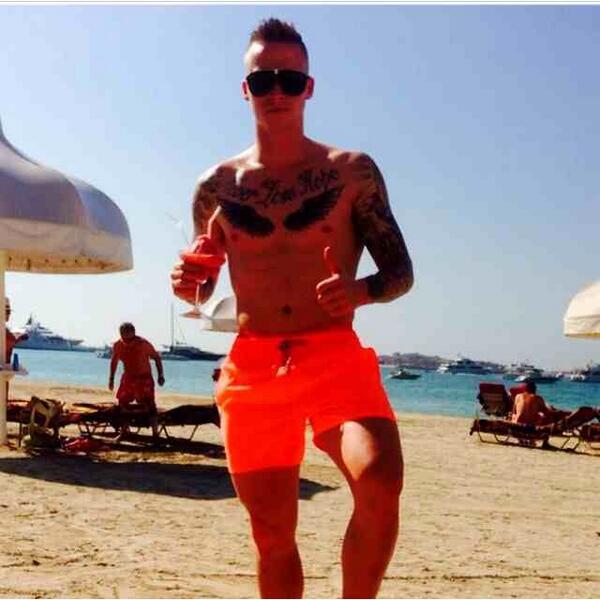 BghxFglIMAAg8kq Man Uniteds Alex Buttner working hard with a fruit cocktail in a pair of outsized shades on the Dubai beach