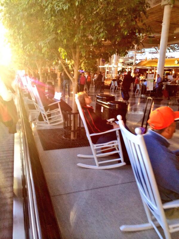 falbey's tweet photo. It's hard to tell, but in Charlotte's airport they don't have benches in the main terminal, they have rocking chairs. http://t.co/AfX0EOZg3E
