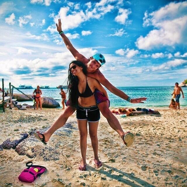 Smiling friends posing on beach Stock Photo - Alamy