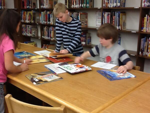 LutherLibrary's tweet image. 2nd graders studying 2013 picture books &amp;amp; trying to guess the Caldecott winners.