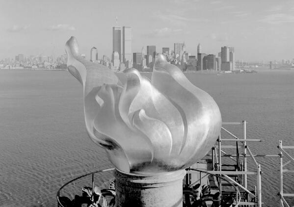 NewYorkologist's tweet photo. Flame of the Statue of Liberty's Torch, 1985 - Twin Towers in Background | #NewYork #nyc #ny http://t.co/pG2e1pBVsA