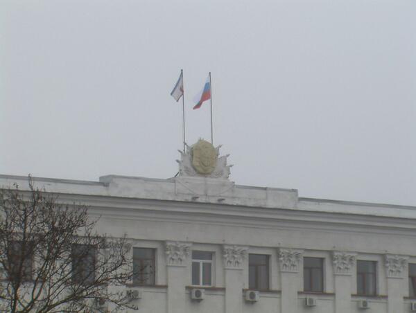 Crimean parliament seized by an unknown armed group. Russian flag raised over building