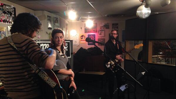 Travis and Sonia doing paperwork while joe watches