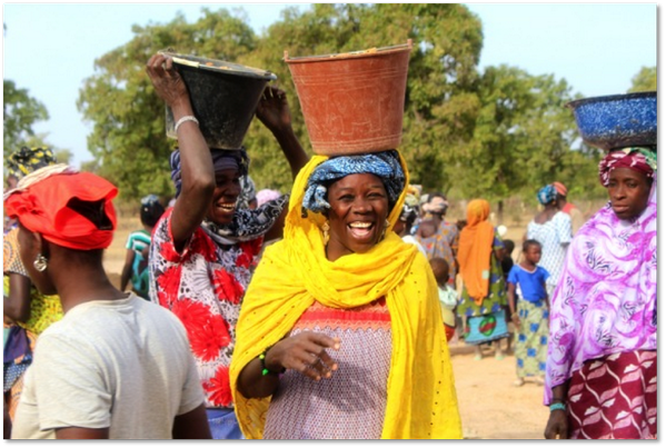 Sanata from #Mali who has never been to school.  Carrying water to build a school for her daughter #buildon #IWD2014