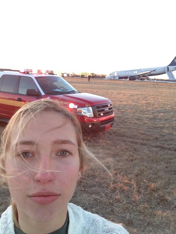 a woman taking a selfie in front of a plane