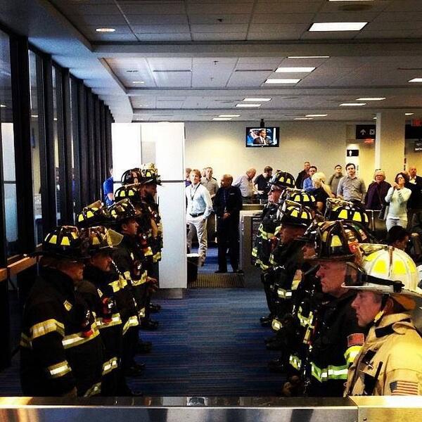 thfd316's tweet image. Boston brothers waiting at the airport for one of the fallen firefighters mother.