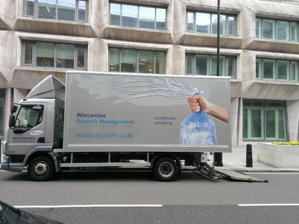 markath's tweet image. This struck me as odd, supposedly secure shredding yet they can't even close the bag in the picture on their van.