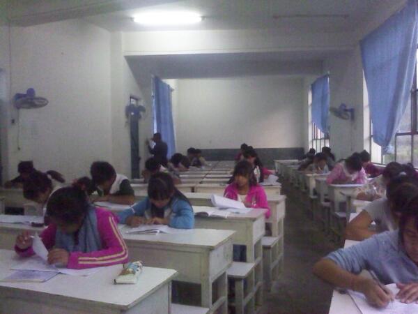 My 9th graders take their bi-monthly exams in bad lighting for the 中考. A local teacher fixes lights in the back.