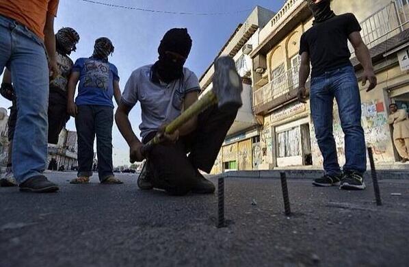 Reality_Bahrain's tweet photo. #Alwefaq Hammering nails into roads, peaceful enough! Isn't it? #Bahrain http://t.co/PtrTUcwGhf