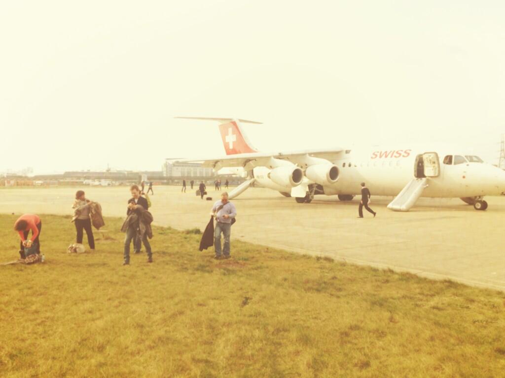 a group of people standing next to an airplane