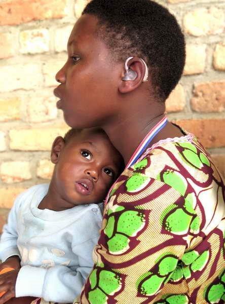 starkeyfnd's tweet image. Young mother in #Rwanda can feel and hear her baby's heartbeat for the very first time thanks to the gift of hearing.