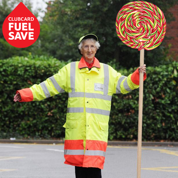 Tesco's tweet image. The &apos;lollipop&apos; lady knows the score... stock up on the essentials and save on that school run fuel with #FuelSave