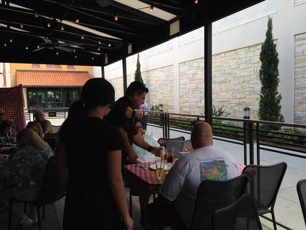 GrimaldisPizza's tweet photo. Officer Alex from @TampaPD serves up a pizza pie as part of #TipACop @WestShorePlz http://t.co/hj0ufsEzKj