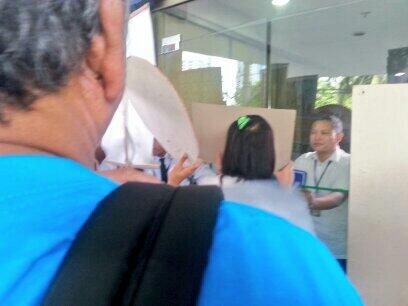 ABSCBNNews's tweet photo. PHOTO: Consumer group POWER! tries to enter ERC building during their protest vs power rate hike http://t.co/07AD7kACew |via @jacquemanabat
