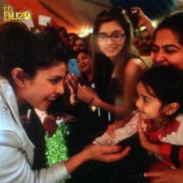 PageantsNEWS's tweet photo. Such a cute picture of Miss World 2000 @priyankachopra with a little girl at #TempaBay for #IIFA. http://t.co/WPM24nN6XU