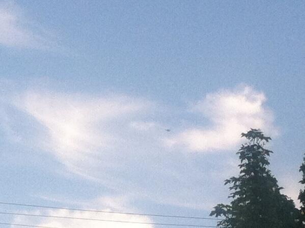 This tiny dot in the sky is a drone hovering over the anarchists.  All eyes on #seamayday #Q13Fox