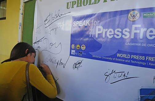 Froigallardo's tweet photo. STAND FOR PRESS FREEDOM. A Cagayan de Oro student signs on a tarp during the celebration of Press Freedom Day http://t.co/cJRkvvFmm6