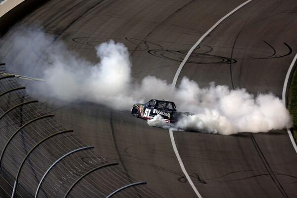 NASCAR_Trucks's tweet photo. PHOTO: @KyleBusch celebrates with a burnout after winning the #SFP250 last night at @kansasspeedway #NASCAR http://t.co/toPNwFm4pg