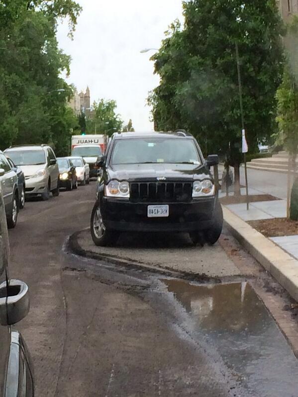 DameSparkula's tweet image. This driver ignored the No Parking notices. They just removed the road from around the car. #LifeinDC #WTF