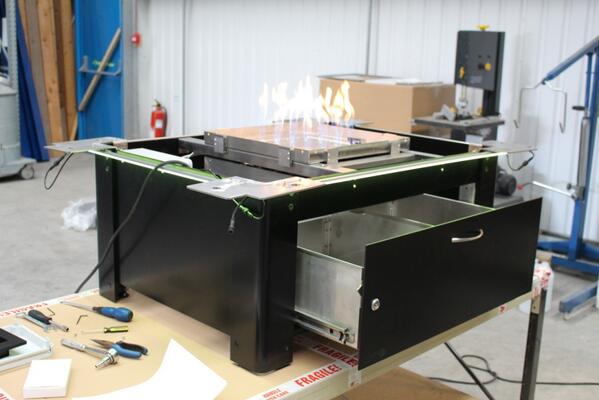 A Bahama fire table during assembly. This one has RGB Led's, a drawer for storage and an ice bucket.