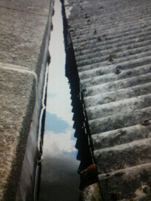 Asbestos roof and blocked gutter lots of leaks