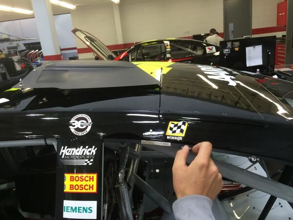 JonEdwards24's tweet photo. "Winner decal" being applied to @JeffGordonWeb's No. 24 @Drive2EndHunger Chevy SS. http://t.co/svhdcjEyht