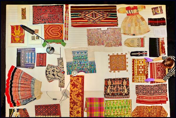 Pitt_Rivers's tweet photo. Behind the scenes our Joint Head of Collections prepares some exquisite textiles for a private visit. http://t.co/hUzg4lC3Vk