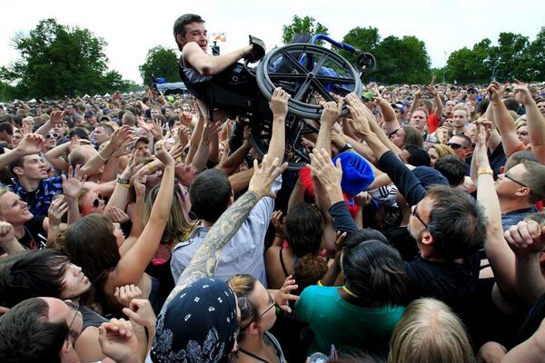 Crowd at rock concert in #KansasCity help disabled man get the best view!