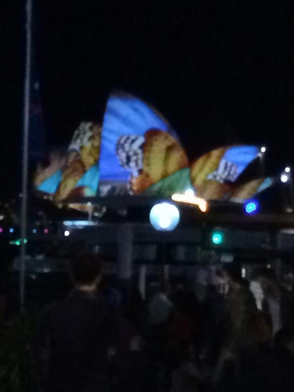 Sydney opera house lit up like a butterfly.