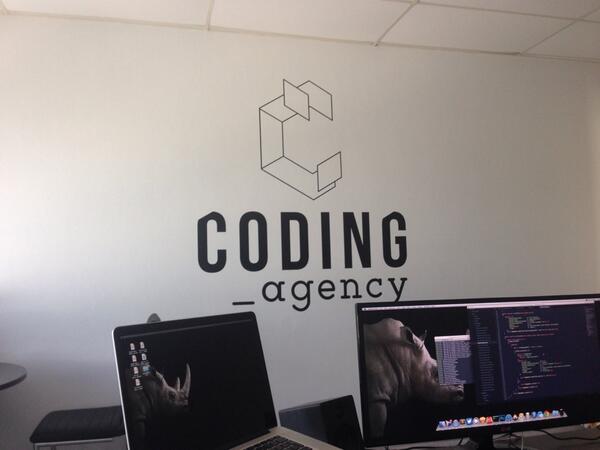 coding_agency's tweet photo. Zojuist de muur laten voorzien van het logo. Later deze week zijn de ramen aan de beurt. http://t.co/qJAPVL8aK6