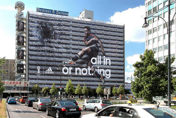 brfootball's tweet photo. 100m x 60m poster: @MesutOzil1088 smashes a hole through huge building in Berlin with football http://t.co/aVGyIsQdCS http://t.co/tsLju8crq7