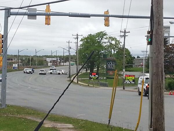 Police in tactical gear around Moosehead cold beer stare on windmill
