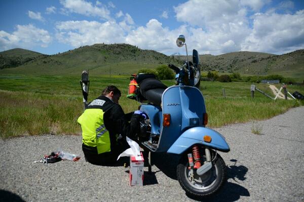 Scooternado's tweet image. Flushing the gas line on the roadside before checkpoint. #fuelproblems