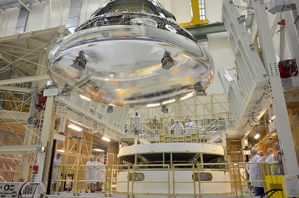 NASA's tweet photo. .@NASA_Orion Comes Together: Here's the space capsule being positioned on the service module http://t.co/UzIBQDq4Er http://t.co/TsesWT1N0C