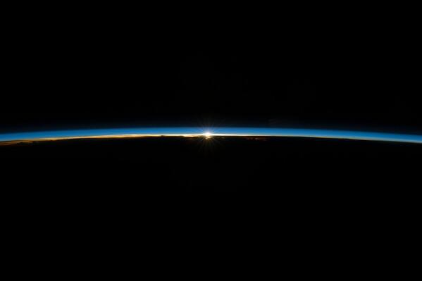 The sun, peeking through the thin line of Earth's atmosphere, as seen from space station. instagram.com/p/pmKdUaIaHM