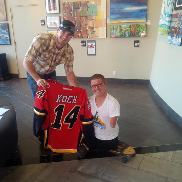 NHLFlames's tweet photo. Curtis Glencross presented Chris Koch (@IHopJRWalks) with a #Flames jersey before he climbed @TheCalgaryTower! http://t.co/SM3IOFXjfL
