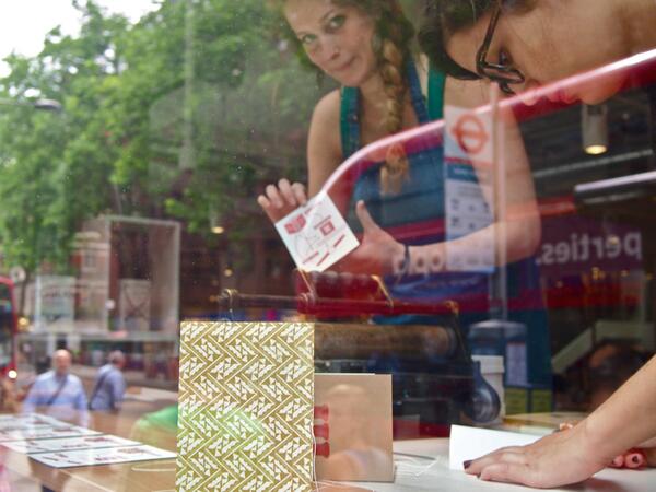 @mraquelsantos and <a href="/AriAriTicTic/">Arianna Tilche</a> printing and binding in the window of the new <a href="/Foyles/">Foyles Bookshop</a> flagship bookstore