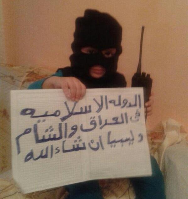 The Daily Mail: A child is pictured ... wearing a balaclava and holding a sign saying 'God is greatest'. WRONG!!!