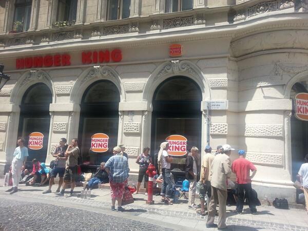 LydsG's tweet photo. Art  #Hungary on inequality b/w rich&amp;poor. 70 ppl queing 4 burger boxes w min wage at fake burger joint @HungerKing1 http://t.co/V4rXvt7Zti