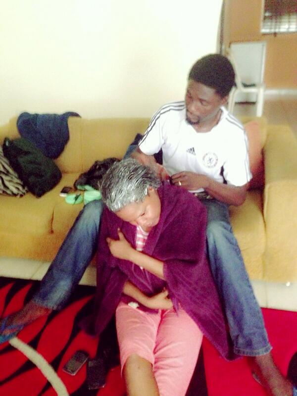 Photo of Adeniyi Johnson relaxing Toyin Abraham's Hair with Ozone Relaxer